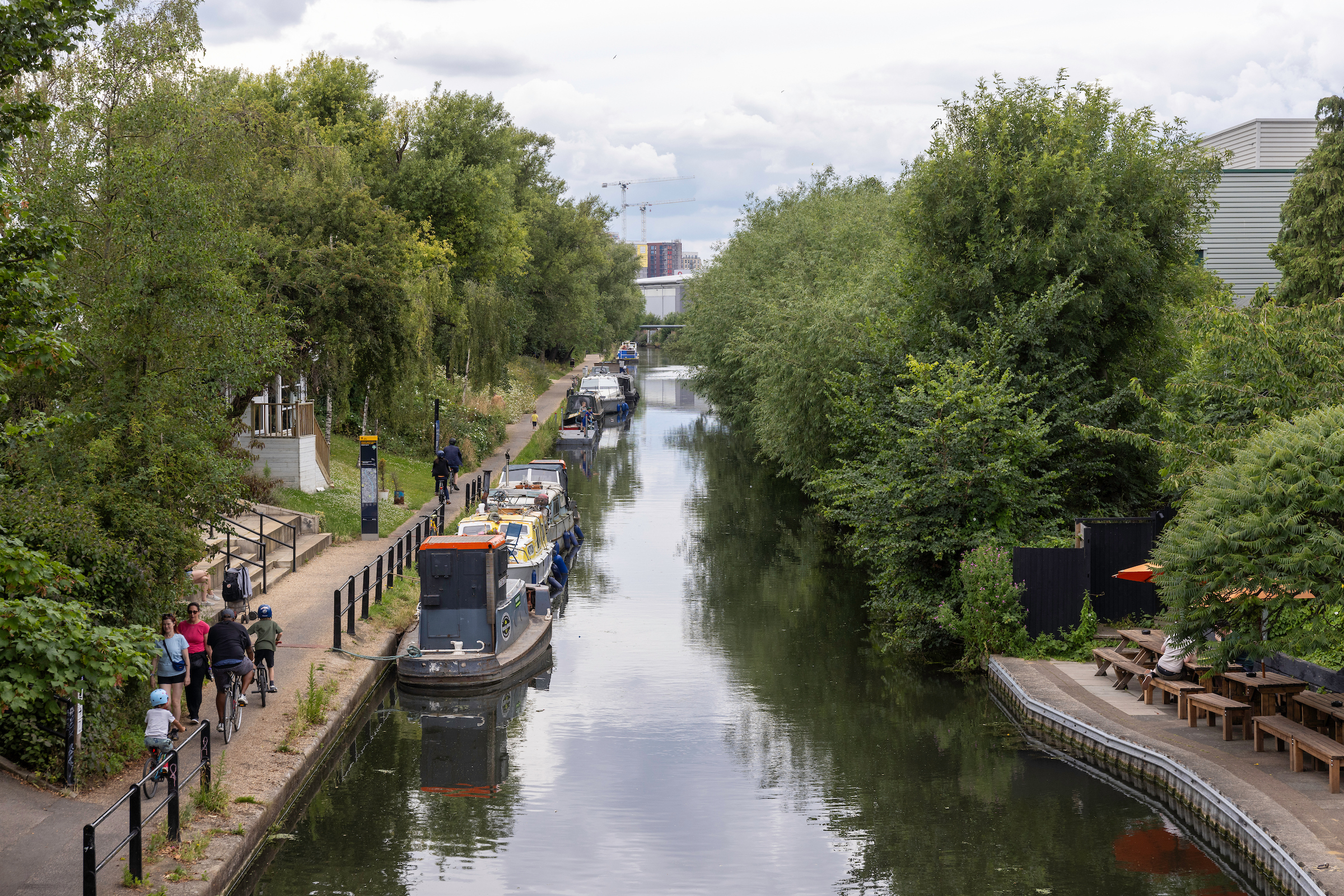 Canalside image with a line of barges on the left-hand side