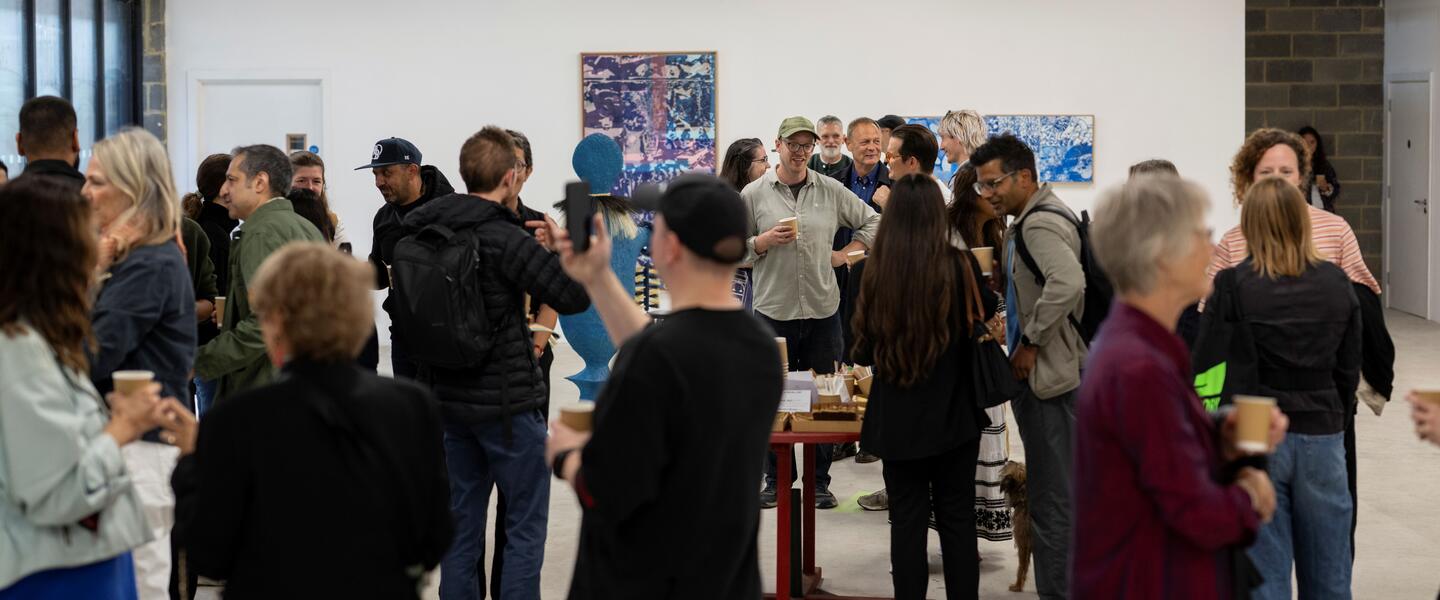 Image of a group of people networking in an art gallery