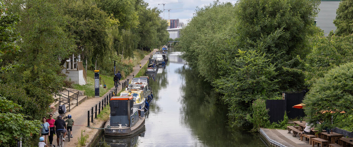Image of a canal with barges along the left-hand side