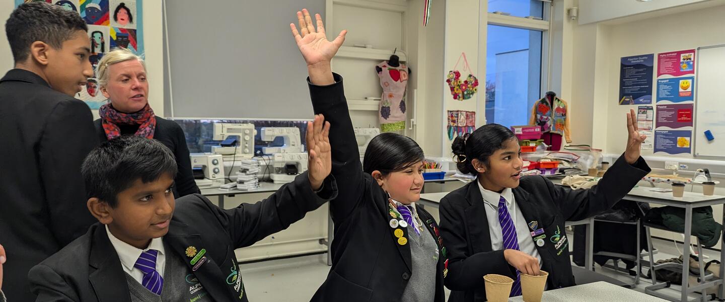 Group of school children in a classroom attending a workshop about plants