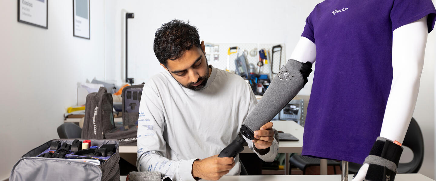 Image of a man working in a lab, creating a prosthetic arm