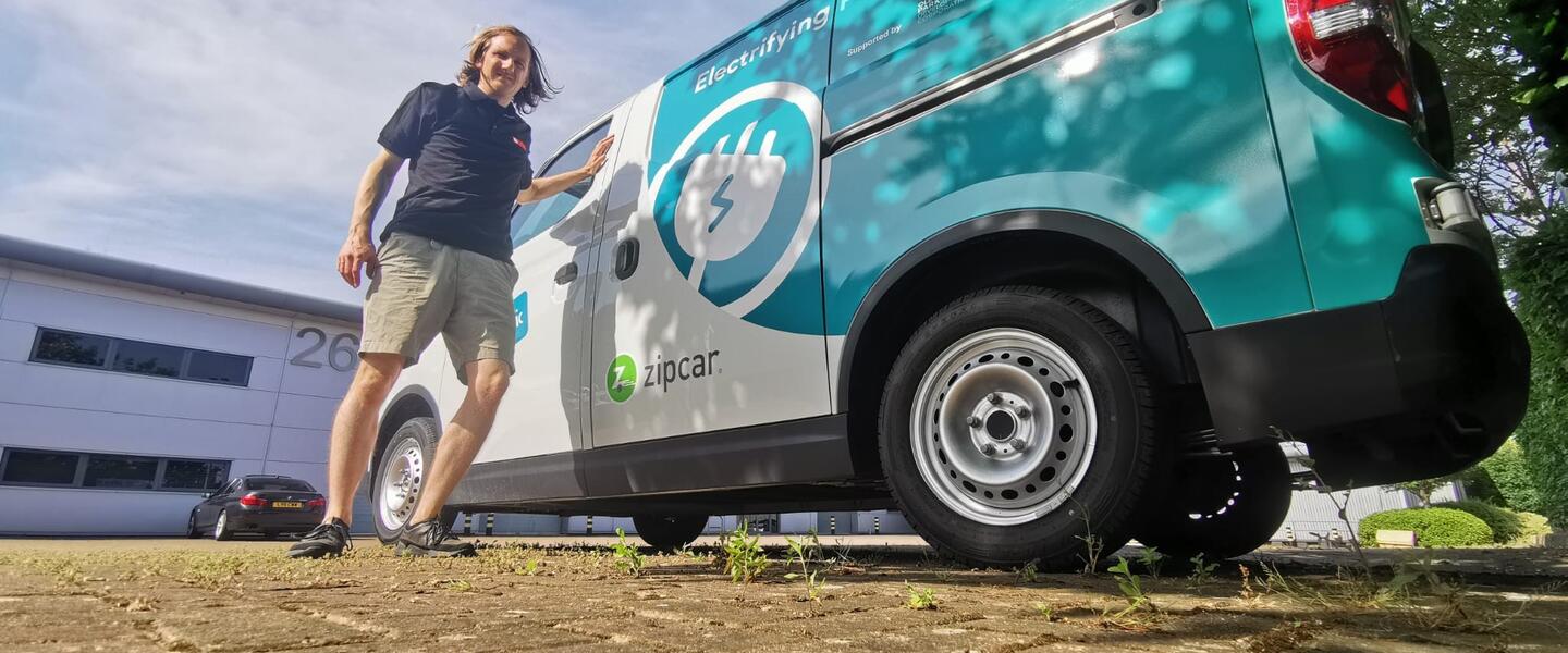 A man stood in front of a Zip Van - a van hire service