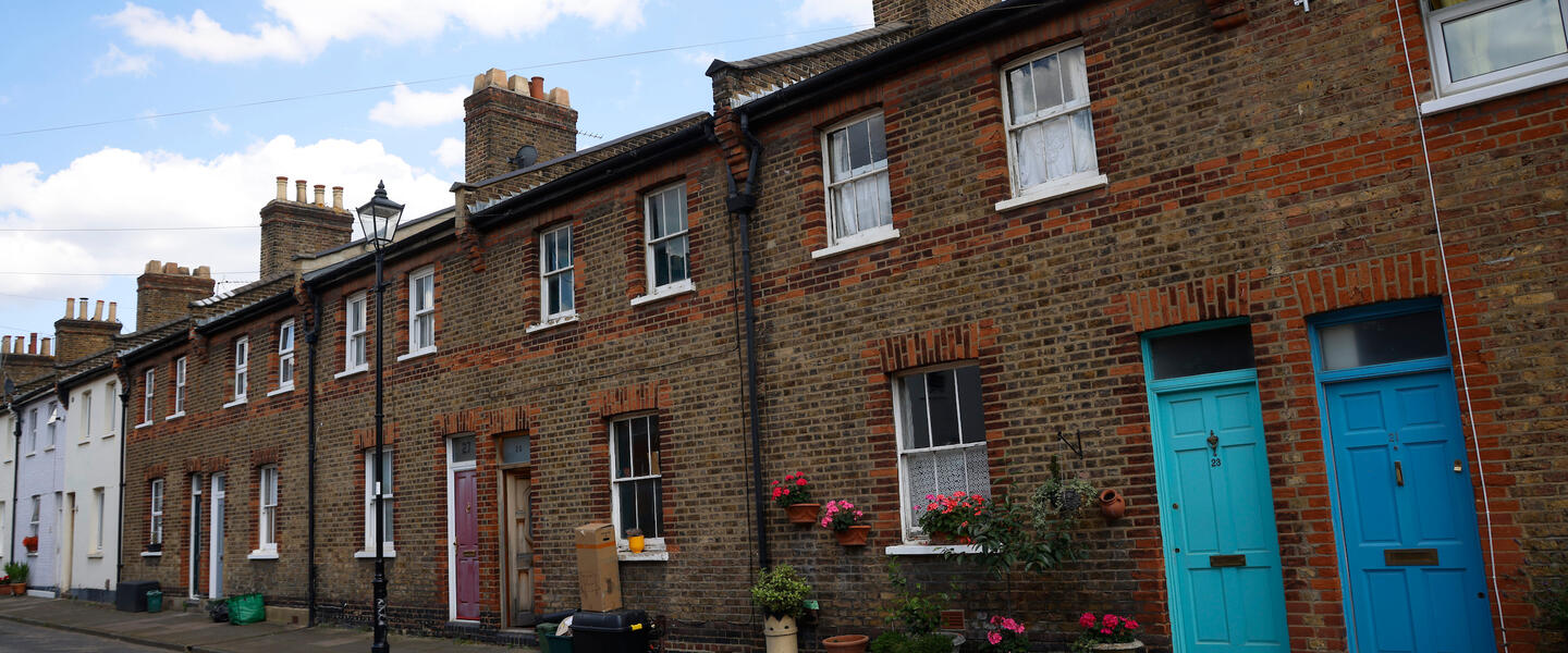 Line of Victorian railway cottages with blue doors