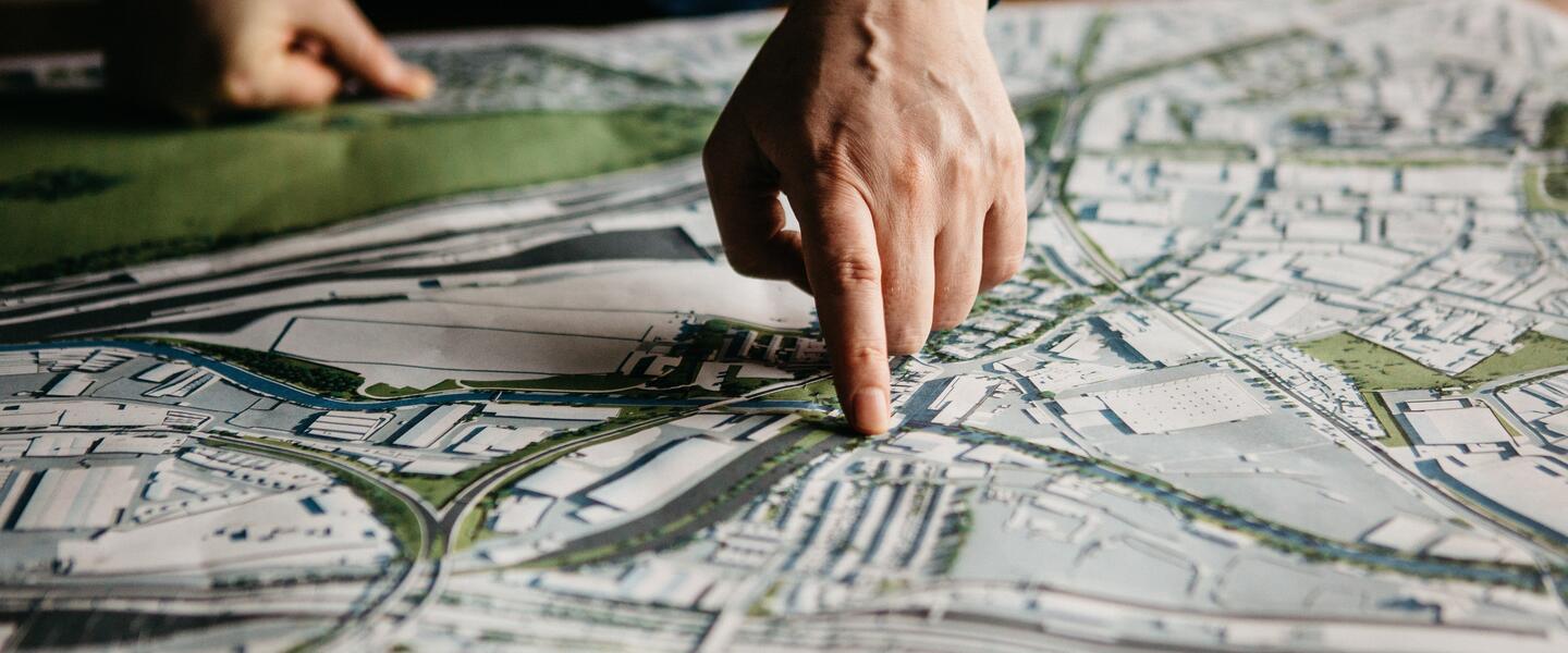 Hand pointing at a map of the OPDC area